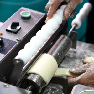 Koplar® chimney cake rolling machine in action